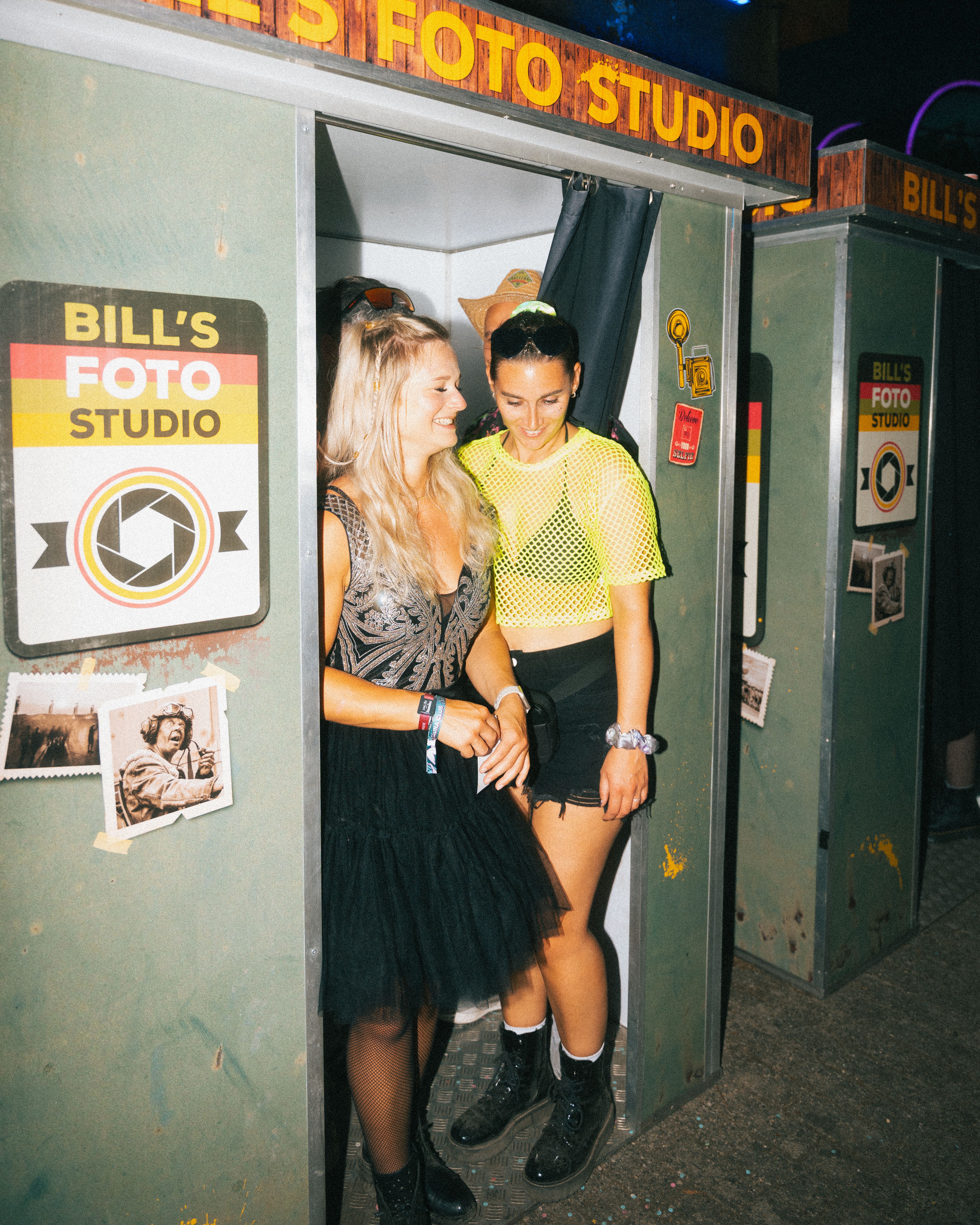 Lachende Frauen verlassen die Flash-U Fotokabine auf einem Festival